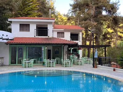 a swimming pool in front of a house at POED Residences in Platres