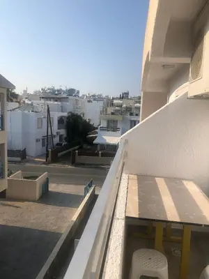 a balcony with a bench on the side of a building at AgiaNapaNest studio in Ayia Napa