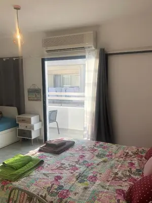 a bedroom with a bed and a sliding glass door at AgiaNapaNest studio in Ayia Napa