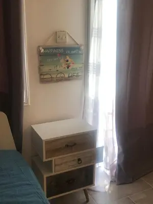 a bedroom with a bed and a dresser and a window at AgiaNapaNest studio in Ayia Napa