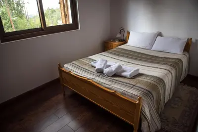 a bedroom with a bed with towels on it at Cherry Cottage in Kato Platres