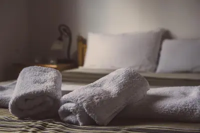 a pile of towels on top of a bed at Cherry Cottage in Kato Platres