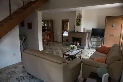 a living room with a couch and a fireplace at Cherry Cottage in Kato Platres