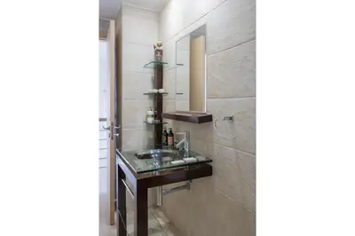 a bathroom with a sink and a mirror at AAA SEAVIEW PANORAMA in Pervolia