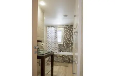 a bathroom with a sink and a shower at AAA SEAVIEW PANORAMA in Pervolia