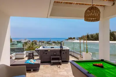 a patio with a pool table and a tub at Fig Tree Bay Residences 3-Jacuzzi-Hotub -Pool in Protaras