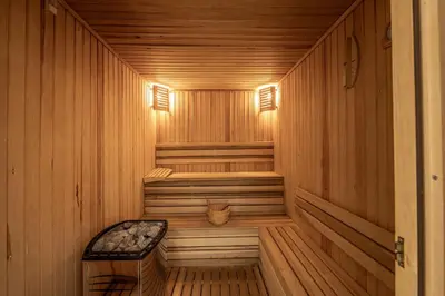a wooden sauna with a bench in the middle at Fig Tree Bay Residences 6 in Protaras