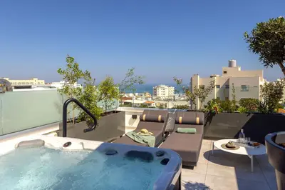 a hot tub on the roof of a building at Fig Tree Bay Residences 7 in Protaras