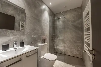 a bathroom with a shower and a toilet and a sink at Fig Tree Bay Residences 7 in Protaras