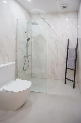 a bathroom with a toilet and a glass shower at Emily apartment in Paralimni