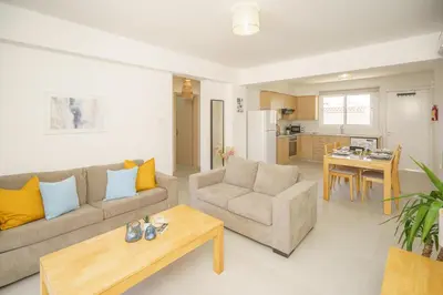 a living room with a couch and a table at Emily apartment in Paralimni