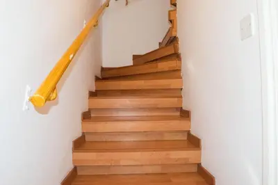 a staircase with wood floors and white walls at Merika Complex 1 Hou.32 in Larnaka