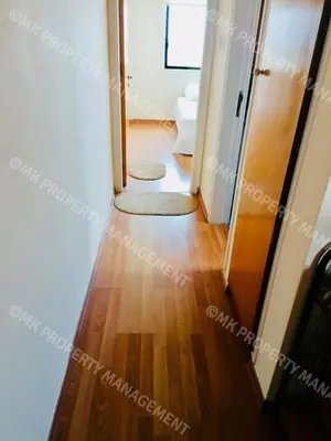 a hallway with two rugs on a hard wood floor at Merika Complex 1 Hou.32 in Larnaka