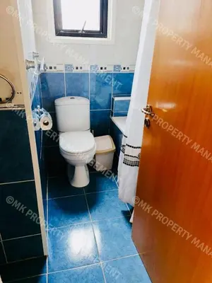 a bathroom with a toilet and a blue tiled floor at Merika Complex 1 Hou.32 in Larnaka