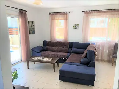 a living room with a couch and a coffee table at Elina villa near the sea in Protaras