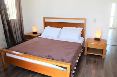 a bedroom with a large bed with two night stands at Elina villa near the sea in Protaras