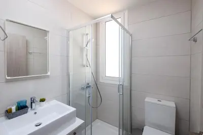 a bathroom with a shower and a toilet and a sink at The Habitat Mediterraneo - Self Check-in in Larnaka