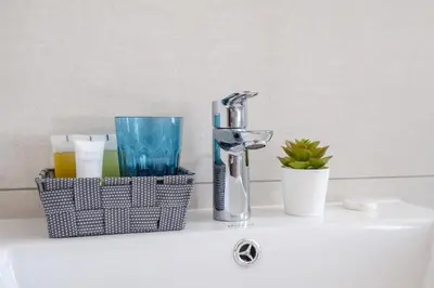 a bathroom sink with a faucet on a counter at The Habitat Mediterraneo - Self Check-in in Larnaka