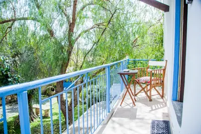 a balcony with a blue railing and a table and chairs at Cecilias Courtyard in Malia