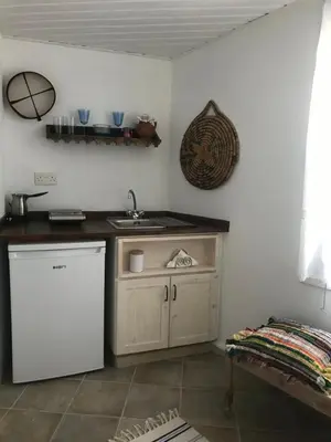 a kitchen with a white refrigerator and a sink at Cecilias Courtyard in Malia