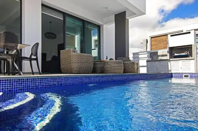 a swimming pool in front of a house at Villa Mey in Protaras