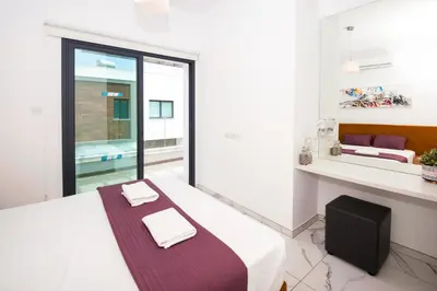 a bedroom with a bed with two towels on it at Villa Mirella in Protaras