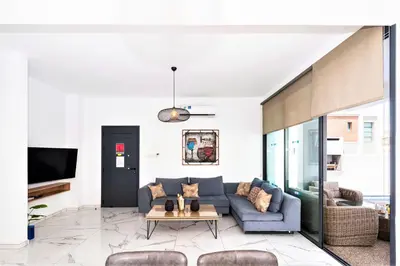 a living room with a blue couch and a table at Villa Mirella in Protaras