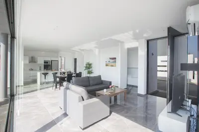 a living room with a couch and a tv at Blue Pearl Villas in Protaras