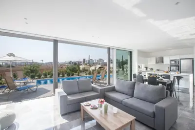 a living room with a couch and a table at Blue Pearl Villas in Protaras