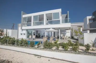 a large white house with a swimming pool at Blue Pearl Villas in Protaras