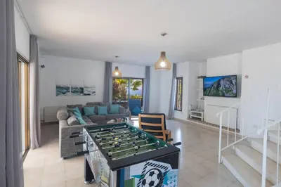 a living room with a foosball table in the middle at Rosie Villa in Ayia Napa