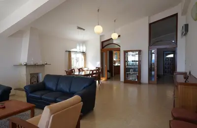 a living room with a blue couch and a table at Sunset Cliff Villa Panoramic Sea Views Private Heated Pool Included in Pissouri