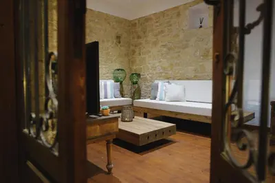 a living room with two beds and a table at Serenity Boutique House in Vouni