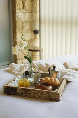 a tray of breakfast food on a bed at Serenity Boutique House in Vouni