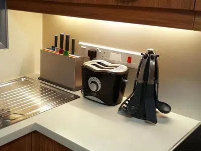 a kitchen counter with a toaster on a counter top at Kennedy Deluxe Suites in Nicosia