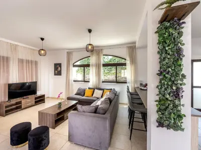 a living room with a couch and a tv at Villa Socrates in Protaras