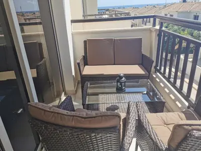 a balcony with a table and chairs on a balcony at Sea view apartment in Protaras