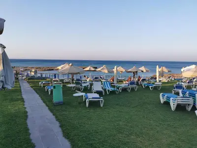 a group of chairs and umbrellas on the beach at Sea view apartment in Protaras