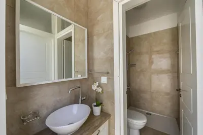 a bathroom with a sink and a toilet and a mirror at Larnaca Villa Marisol Kiti in Larnaka
