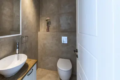 a bathroom with a white toilet and a sink at Larnaca Villa Marisol Kiti in Larnaka