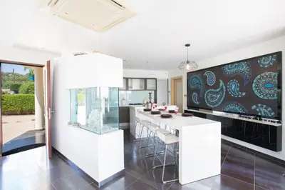 a kitchen with a large white island with bar stools at Oscar Domain Villa in Protaras
