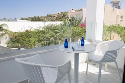 a white table and chairs on a balcony at Fig Tree Bay Residences 1 Lantiana Villa in Protaras