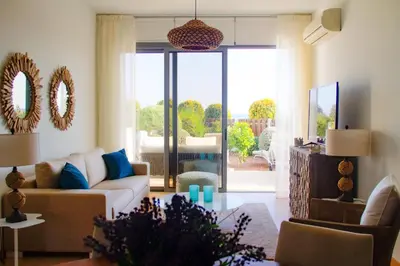 a living room with a couch and a table at Atlantis Gardens in Mazotos