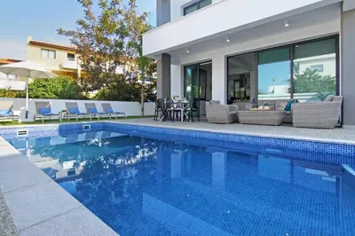 a swimming pool in front of a house at Villa Maritime in Protaras
