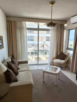 a living room with a couch and a table at 13 Sandy Beach Mackenzie in Larnaka