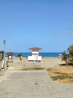 a sandy beach with a lifeguard station on the beach at 13 Sandy Beach Mackenzie in Larnaka