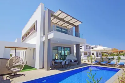 a villa with a swimming pool and a house at Villa Melody in Protaras