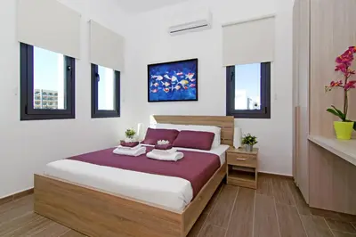 a bedroom with a bed with two towels on it at Villa Melody in Protaras