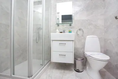 a bathroom with a shower and a toilet and a sink at Galatex Beach Living by TrulyCyprus in Limassol