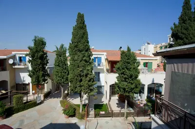 a group of trees in front of a building at Galatex Beach Living by TrulyCyprus in Limassol